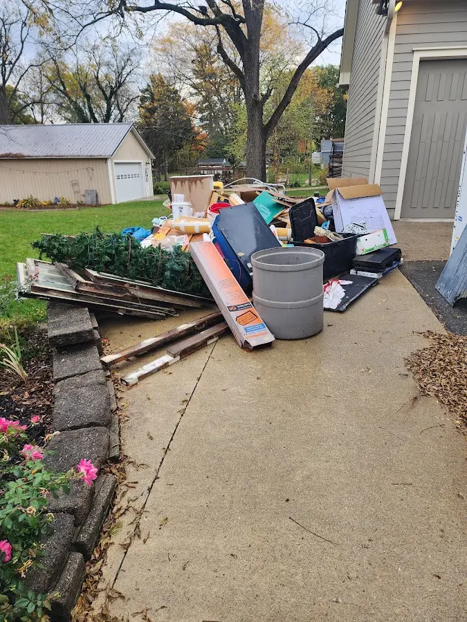 Dumpster being loaded with debris for Estate Cleanout Dumpster Rental in Priceville